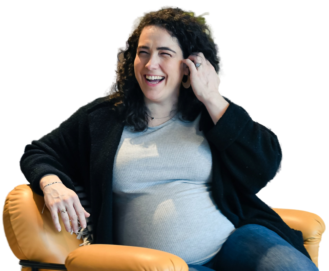Dr. Tara Morrison laughing, seated in a leather chair, pregnant